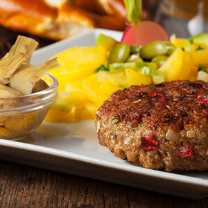 Hamburger with artichoke, sun-dried tomatoes and olives